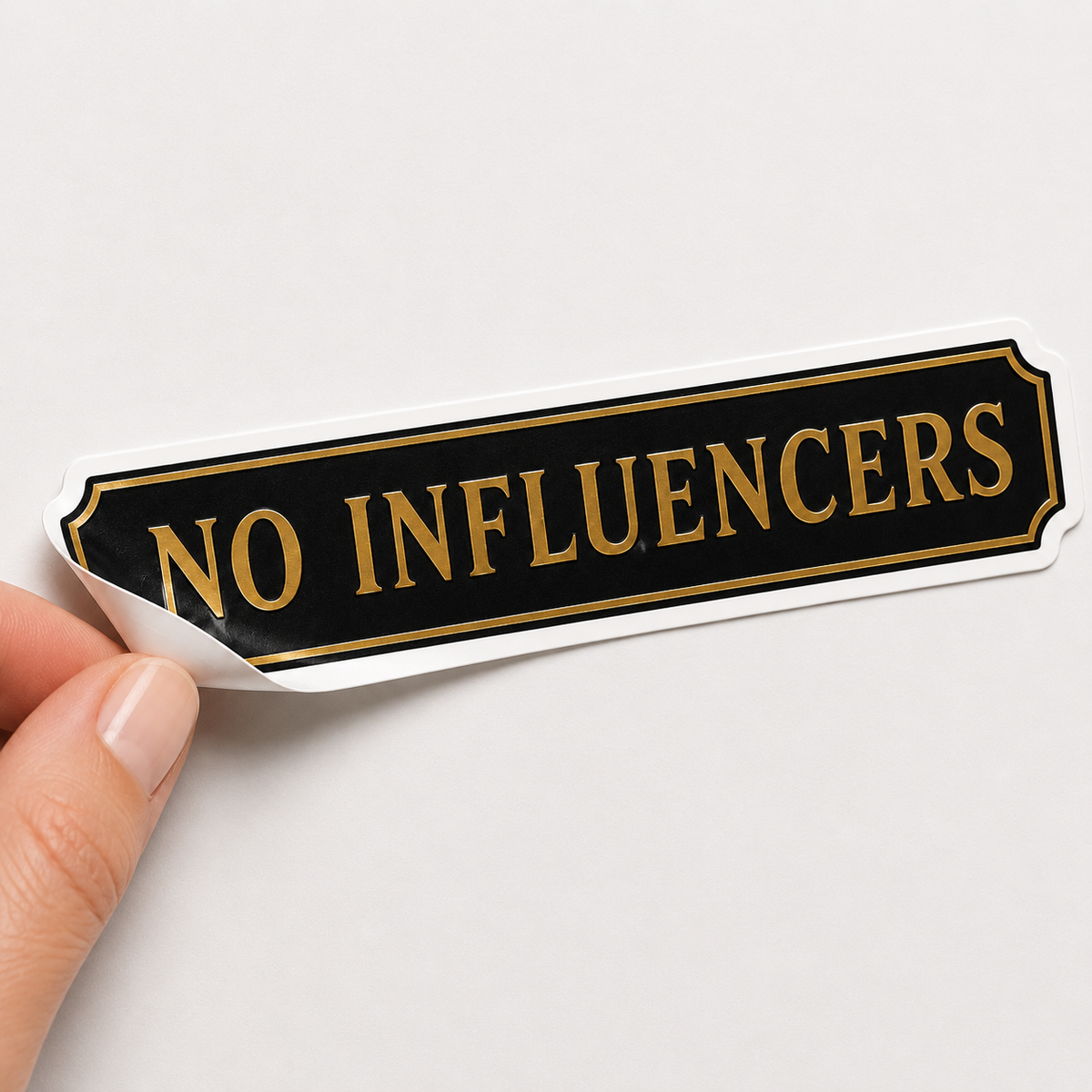 Illustrated black and gold No Influencers Nantucket die-cut sticker inspired by the island’s viral summer sign.
